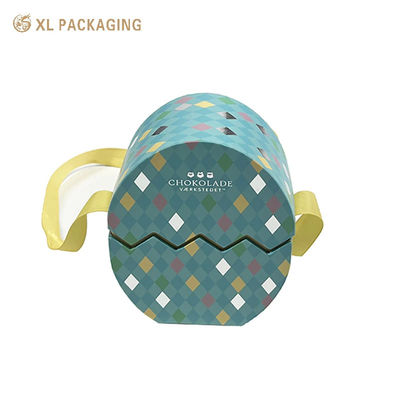 comprar Caja de regalo de chocolate de huevo de Pascua hecha a mano con logotipo plateado en relieve personalizado con embalaje decorado con cinta Fabricación en línea