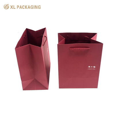 Bolsa de regalo de papel rojo de vino de lujo con logotipo personalizado, fondo doblado reforzado y asas de papel retorcidas para compras premium y embalaje de regalos