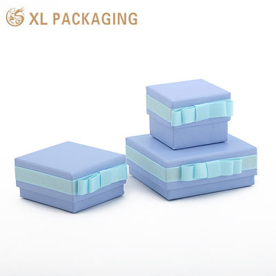 Caja de regalo pequeña y rígida con cartón de 1000 g/m², lazo de cinta azul claro e inserto de esponja multirranura para embalaje de joyería