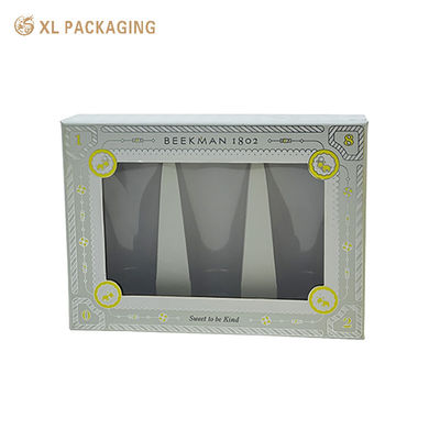 Caja de regalo impresa a medida con material de cartón rígido de ventana PET transparente y estampado de papel plateado para cosméticos